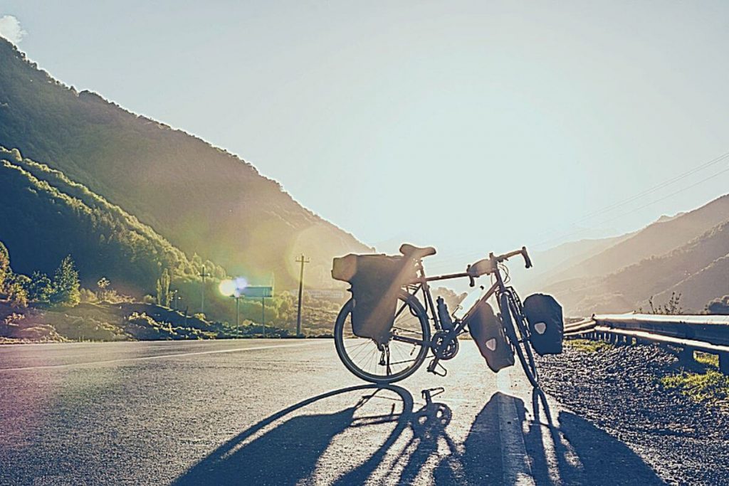 Road bike with pannier bags at side of road