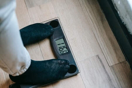 Man standing on a digital weighing scale