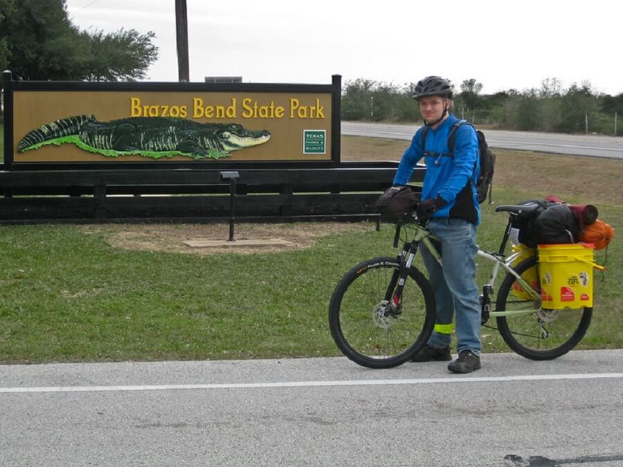 Man on a bicycle loaded with bags at the Brazos Bend - Flickr Image