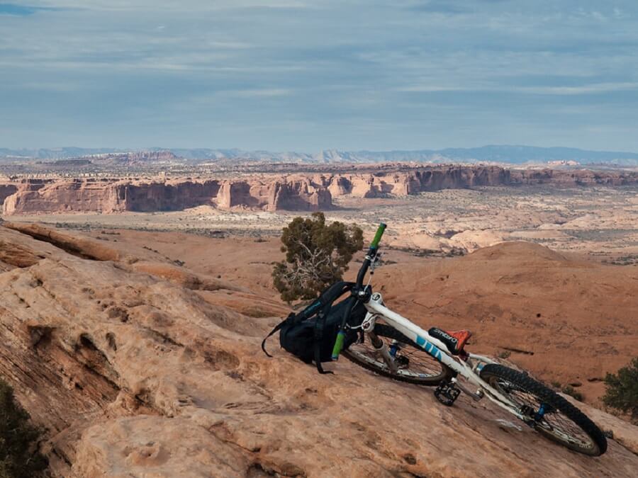 bicycle with backpack leaning against rocks in Slickrock trail, Moab - Flickr image