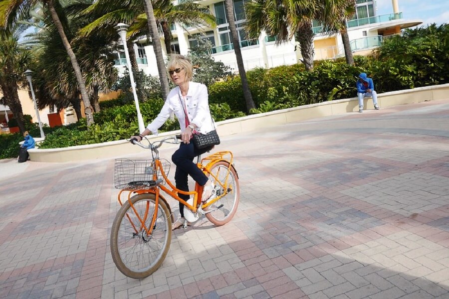 woman in orange bicycle cycling in the morning around South Beach Trail - Flickr image