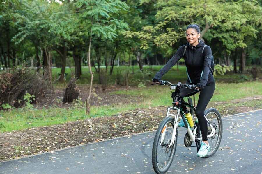 Healthy fit woman riding a bike