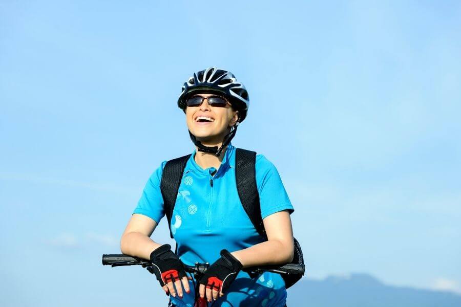 Stress-free woman on bike wearing complete accessories