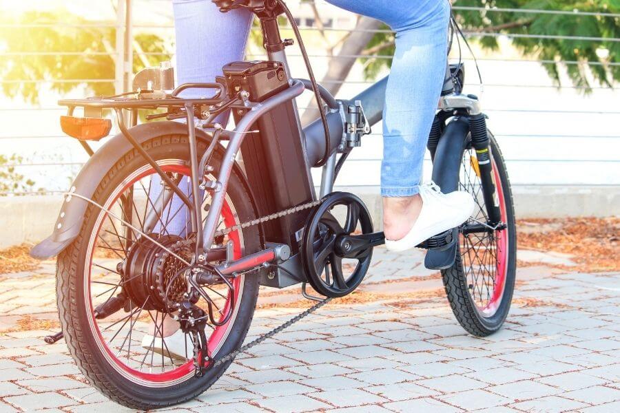 Female commuter riding on electric bike