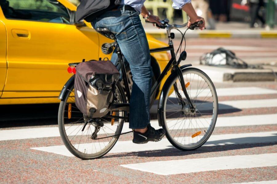 Male bike commuter on pedestrian holding a brake