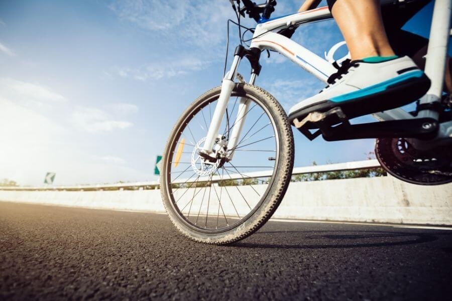 Fit woman commuting by bike on the highway