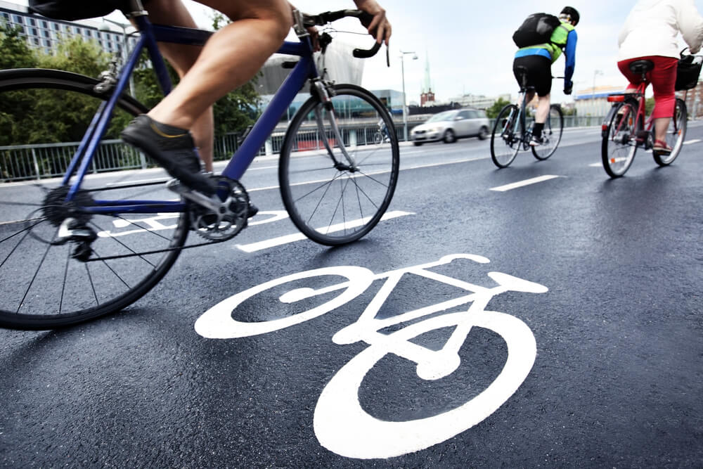 Cyclists commuting to work on a wet road