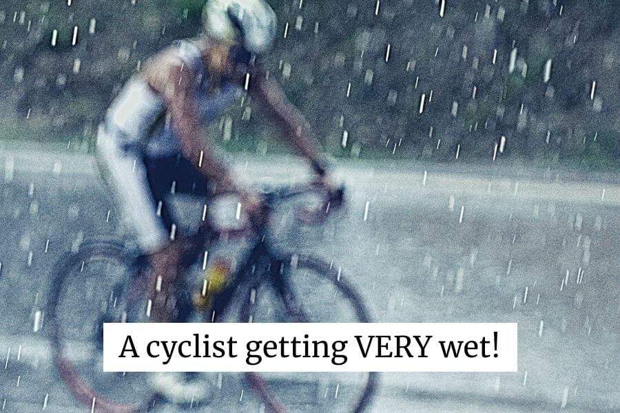 A bike rider getting very wet in the rain
