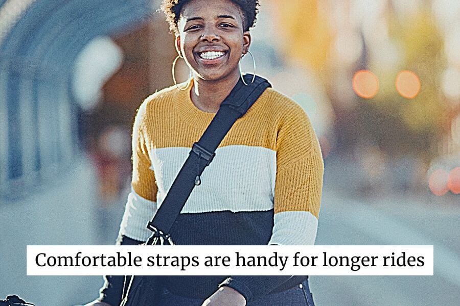 woman with wide straps messenger bags on a bike