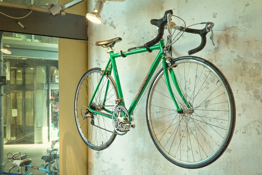 Green road bike hanged on wall