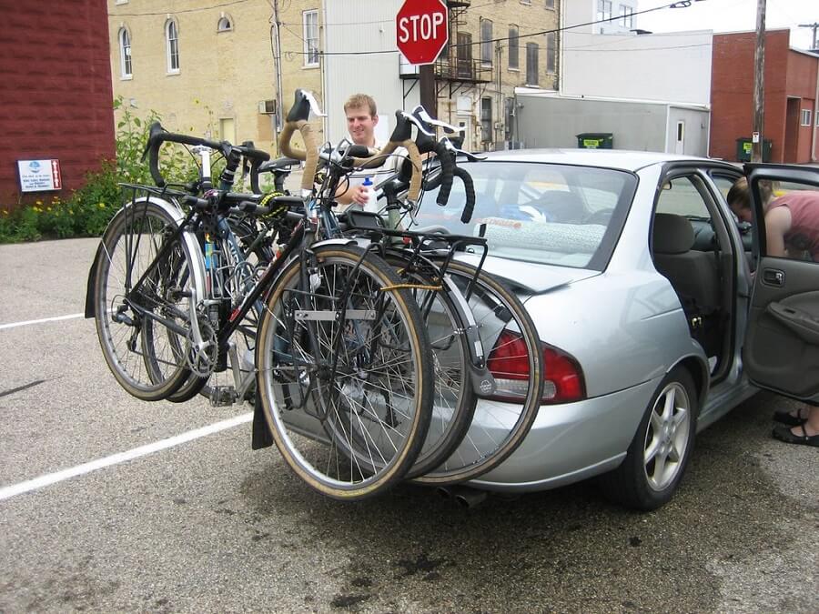 Three Bikes Mounted On A Trunk Rack
