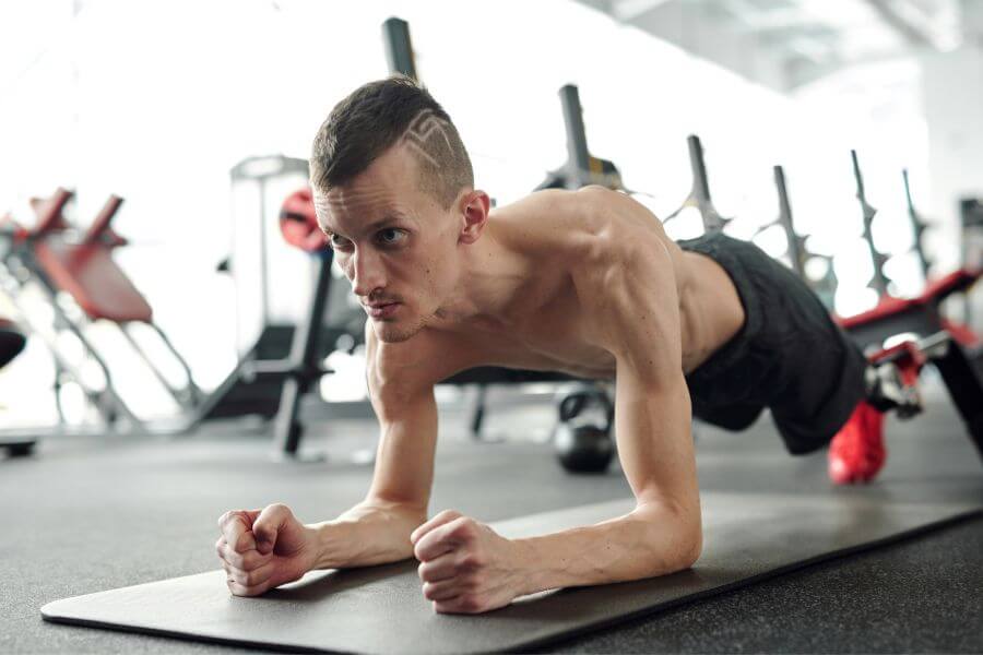 A man doing the plank at the gym
