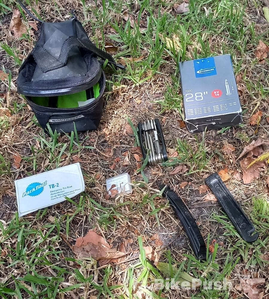 bike saddle bag with essentials on the ground