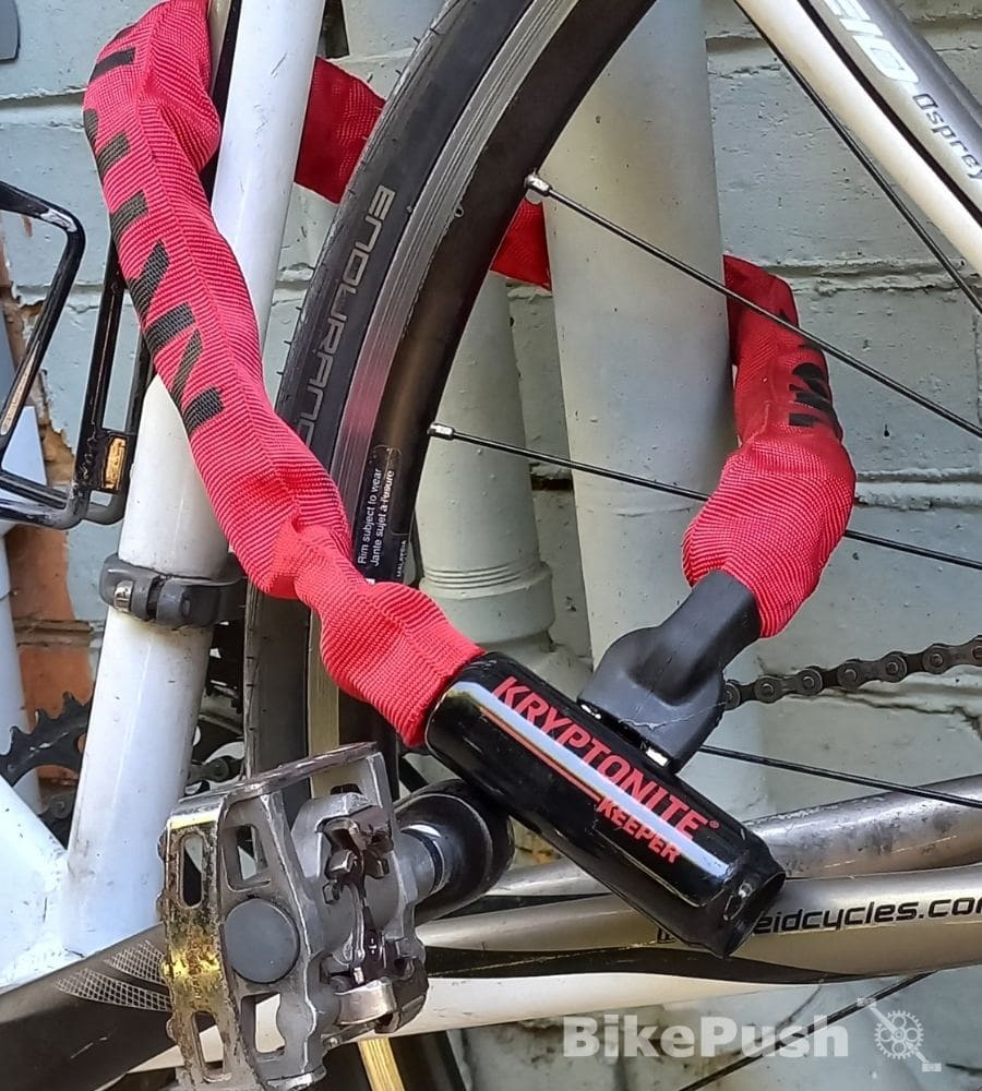 bicycle locked to a drainpipe