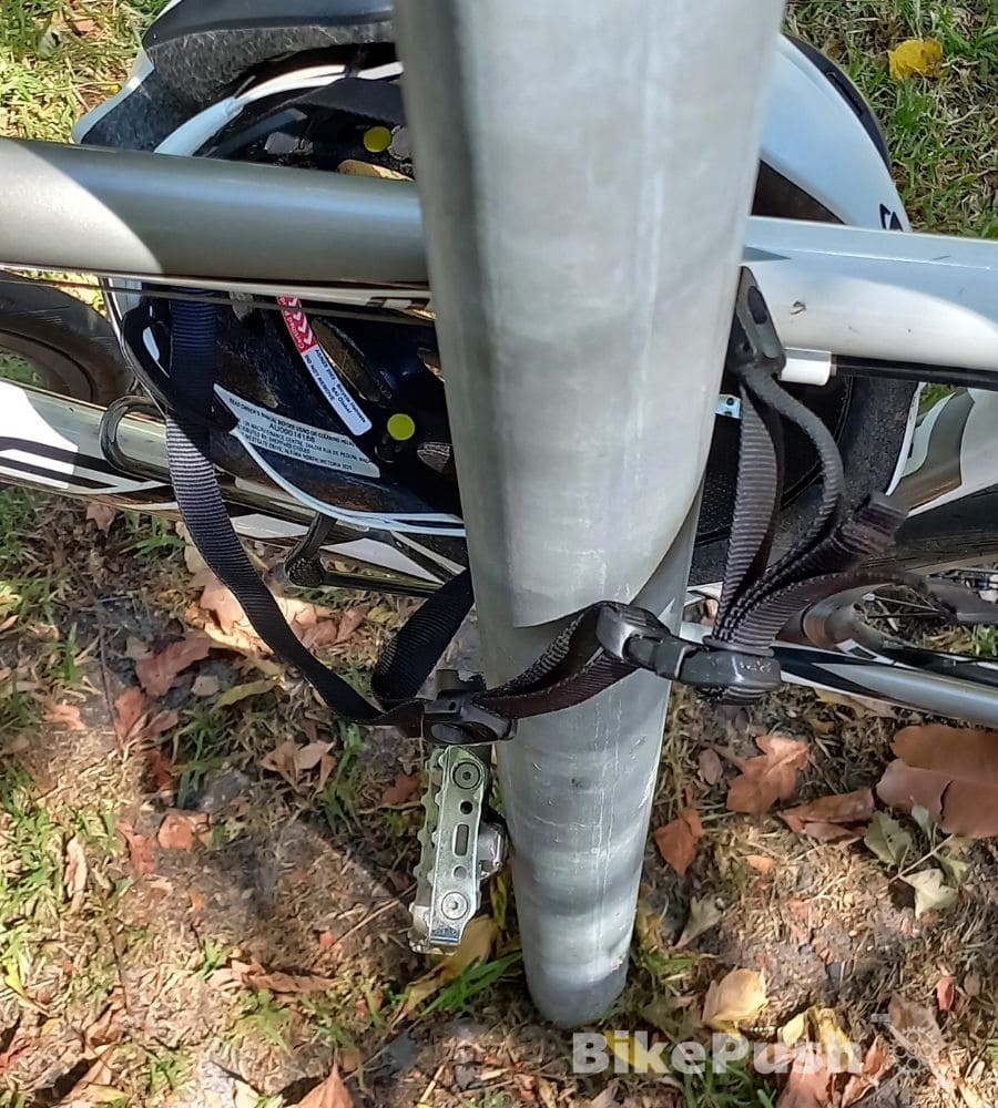 Locking a bicycle with the straps of a bike helmet