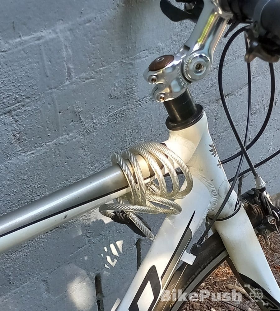 cable lock wrapped around bicycle top tube