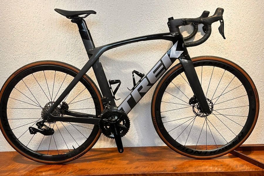 black Trek Madone leaning against a wall
