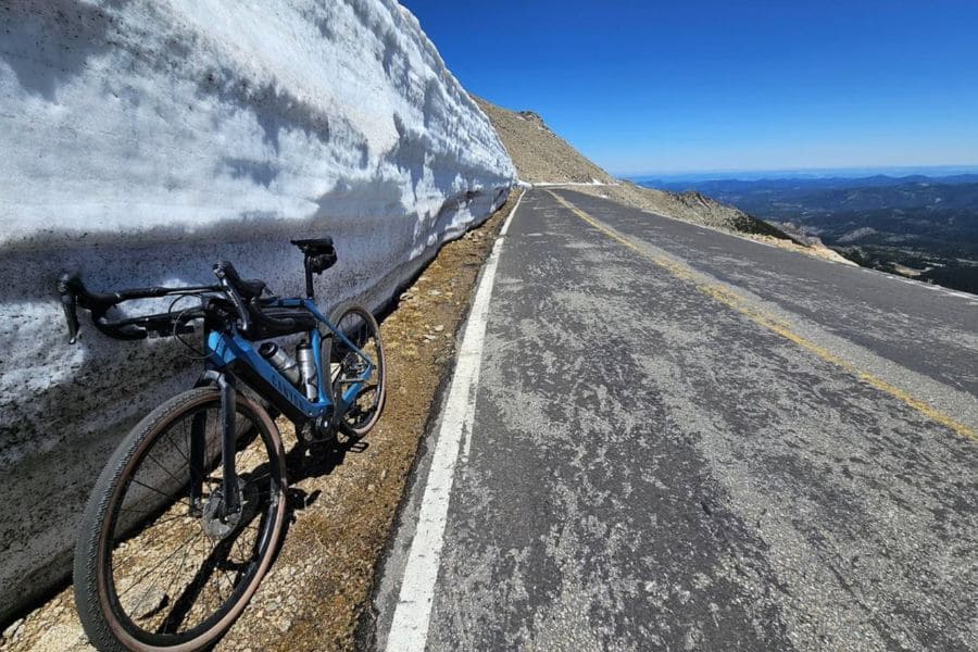 blue bike leaned up against ice sheet in US