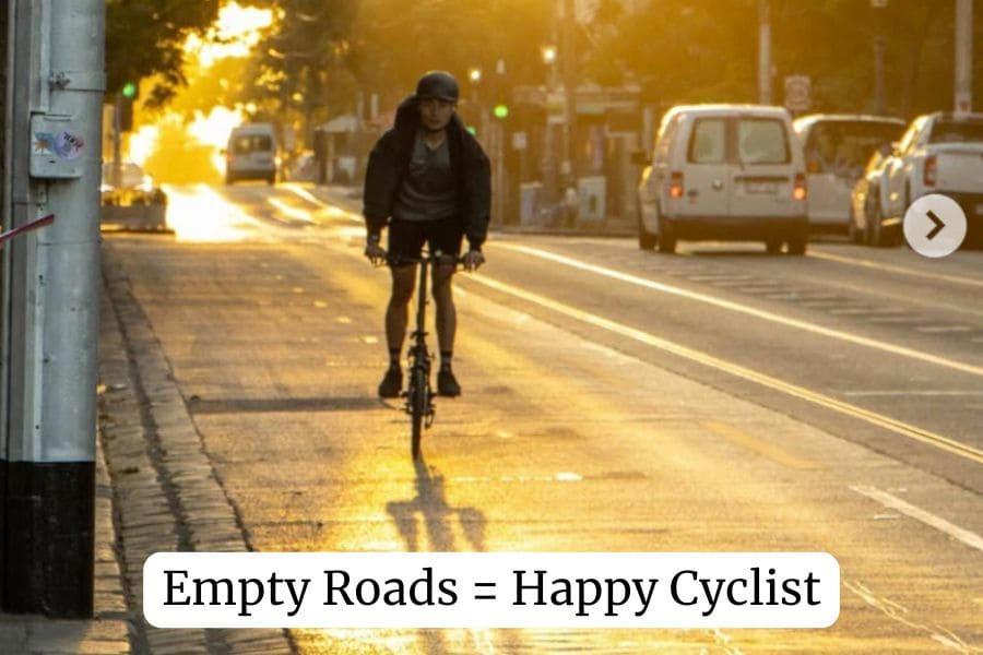 cycling early morning on road with few cars