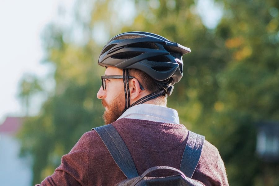 Man with cycling helmet on wearing glasses