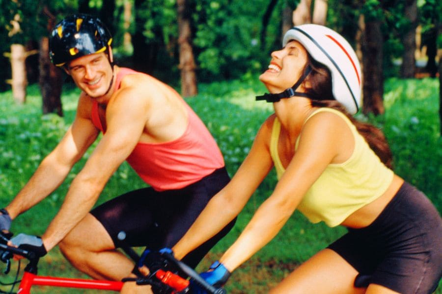 Woman and man happy riding bicycles