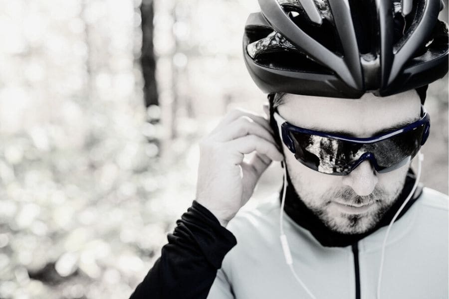 Cyclist putting headphones into his ears